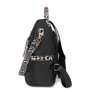 Side view of leopard print nylon backpack with adjustable straps and tassel details