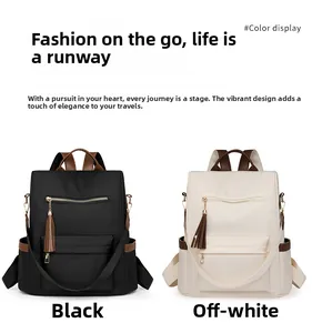 Detail view of large capacity nylon backpacks in black and beige with leather accents