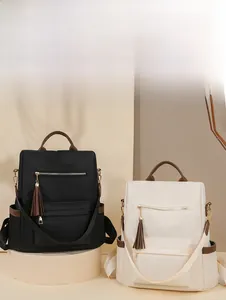 Detail of nylon backpacks with contrasting handles and tassel zipper in a stylish setting
