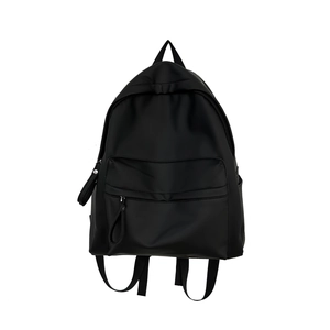 Minimalist black large capacity nylon backpack for school and travel shown on white background
