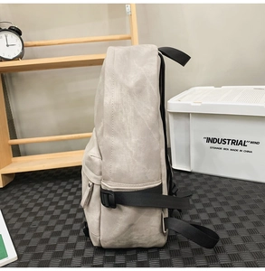 Side view of beige industrial fabric backpack showing large capacity and black buckles