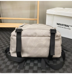 Detail of the durable grey backpack base featuring black nylon straps and plastic buckles