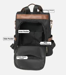 Detail view of large capacity black backpack showing internal pockets and zippers