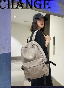 Close-up of lightweight grey student backpack with large pockets in modern hallway