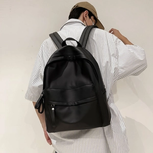 Detail of the black waterproof nylon backpack showing its large capacity and side water bottle pocket
