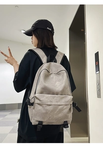 Detailed side view of street style backpack with adjustable buckles and zippered pockets