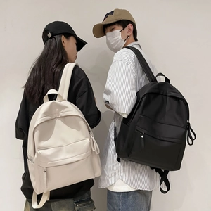 Minimalist nylon backpacks in black and beige shown on models for commuting use