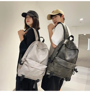 Spacious street style backpacks in grey and green colors shown by fashion models