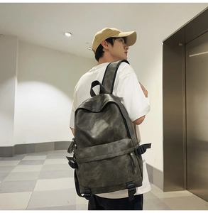 Detail view of dark grey waterproof backpack with retro texture and adjustable side buckles