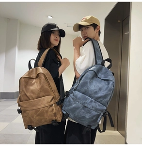 Brown and grey-blue retro student backpacks shown on models in a corridor setting