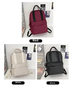 Travel laptop backpack shown in red, white and black colors with a large front pocket