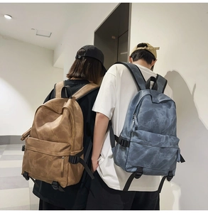 Detail of high-density canvas backpacks showing matte texture and buckle in two colors