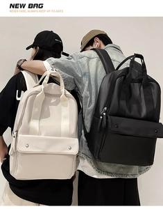 Minimalist cream and black waterproof backpacks shown in a lifestyle couple photography