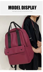 Burgundy large-capacity backpack with padded straps and top handles for travel