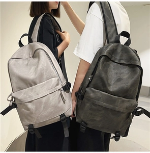 Modern streetwear backpack detail showing grey and olive color options and marble texture