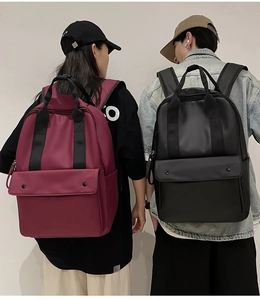 Deep red and black travel backpacks with large front pockets and dual carry handles