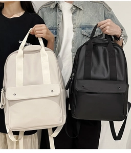 Detail view of large capacity waterproof nylon backpacks in black and beige cream colors
