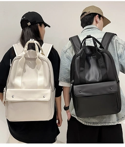 Minimalist waterproof backpack featuring front pocket with dual metal buckle closures