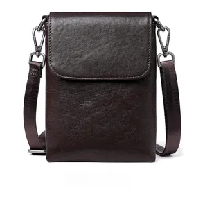 Front view of a dark brown vegetable tanned leather mobile bag with a woven strap