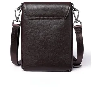 Detail view of the back of a dark brown pebble leather crossbody phone bag with strap