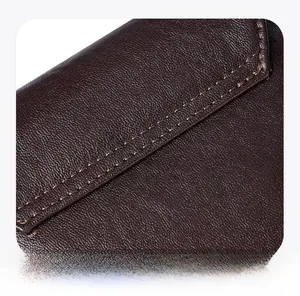 Detailed macro view of high-quality brown leather texture and precise double stitching