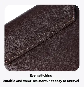 Detail of premium dark brown pebbled leather bag with precision double stitching