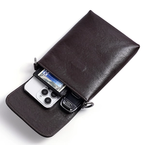 Minimalist vegetable tanned leather crossbody phone bag with compartments for daily essentials