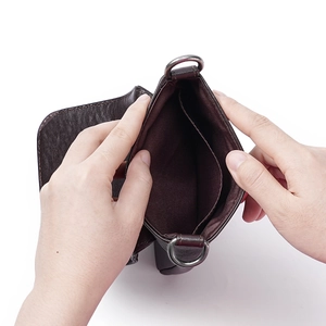 Minimalist dark brown veg-tanned leather crossbody bag showing inner compartments