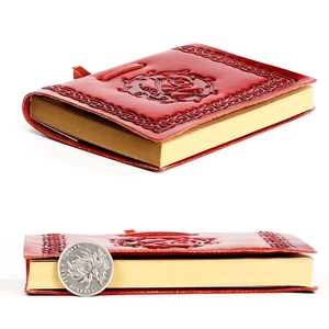 Detail showing the thickness of the rose embossed leather notebook using a coin scale