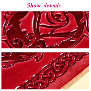 Detailed macro view of red leather cover with embossed rose patterns and woven texture