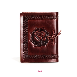 Detail of embossed rose and Celtic knot border on retro handmade leather notebook cover