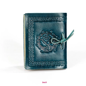 Macro detail of dark teal leather notebook cover with Celtic knots and rose relief
