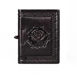 Close-up of vintage brown leather notebook cover with embossed rose and Celtic knot patterns