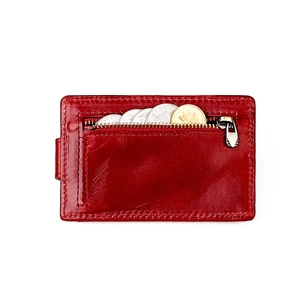 Close-up of red leather wallet with smooth metal zipper and internal coin compartment