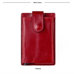 Detail of red genuine leather card holder with pop-up aluminum case and snap closure