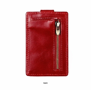Macro shot of red leather card holder with back zipper and refined stitching details