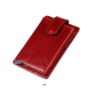 Detail of red leather wallet showing sturdy stitching and automatic pop-up card slider