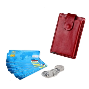 Detail of red pebbled leather card holder with secure snap button and coin pocket
