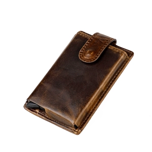 Detail view of vintage dark brown leather wallet with pop-up card holder mechanism