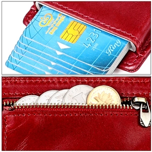 Detail of reddish-brown leather wallet with pop-up card slots and secure zipper coin pocket