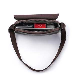 Deep brown leather crossbody bag showing spacious interior with tablet and daily essentials