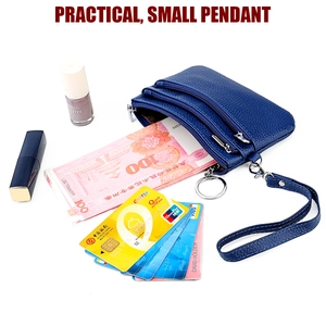 Deep blue lychee leather coin purse with three zippers and wristlet showing storage capacity