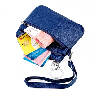 Detail of blue lychee grain leather wallet with triple zipper and wrist strap