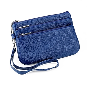Detailed side view of navy blue pebbled leather wallet with three zipper compartments