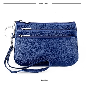 Detail of navy blue genuine leather coin purse with triple zippers and wristlet strap