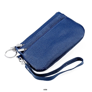 Detail view of navy blue lychee grain leather wallet with triple zipper and wrist strap
