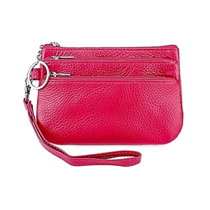 Detail of genuine leather wristlet wallet with three zipper pockets and pebble texture