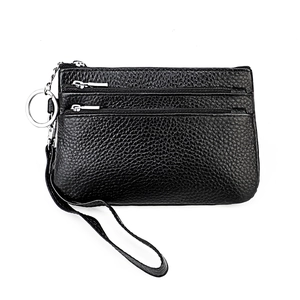 Detail of black lychee grain leather wallet with three zippers, wrist strap and key ring