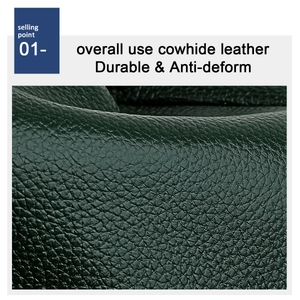 Detailed close-up of dark green cowhide leather with natural lychee grain texture