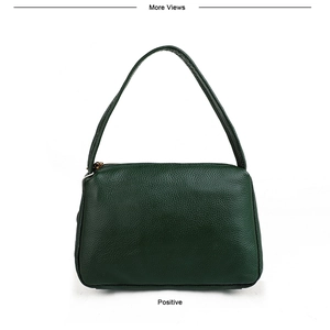 Close-up of high-quality dark green pebbled leather texture on a mini shoulder bag